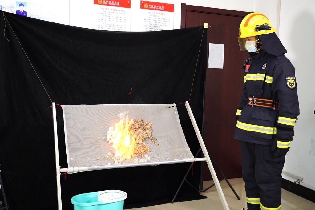 消防員在展示柳絮點燃實驗。 張少欣 攝