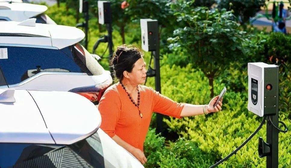 2023年5月24日，山東省膠州市新立街小區(qū)內(nèi)一位居民使用電動(dòng)汽車充電樁掃碼充電。該小區(qū)加裝各類智慧設(shè)備，打造“智慧社區(qū)”，為居民生活帶來(lái)便利。