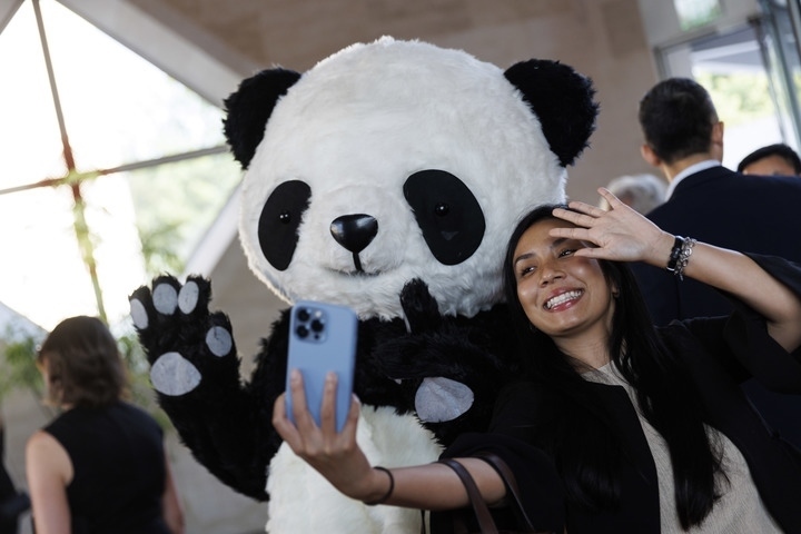 2022年8月24日，在美國華盛頓中國駐美國大使館，來賓與大熊貓玩偶合影。
