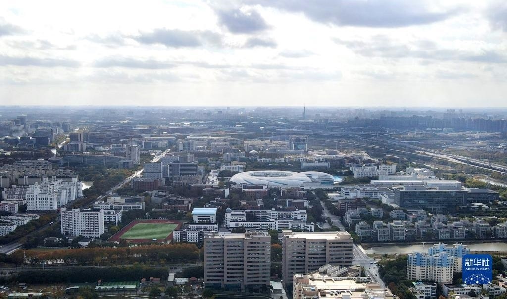 這是2023年11月25日在上海浦東新區(qū)張江科學城拍攝的形如鸚鵡螺的大科學裝置上海光源（中）（無人機照片）。新華社記者 方喆 攝