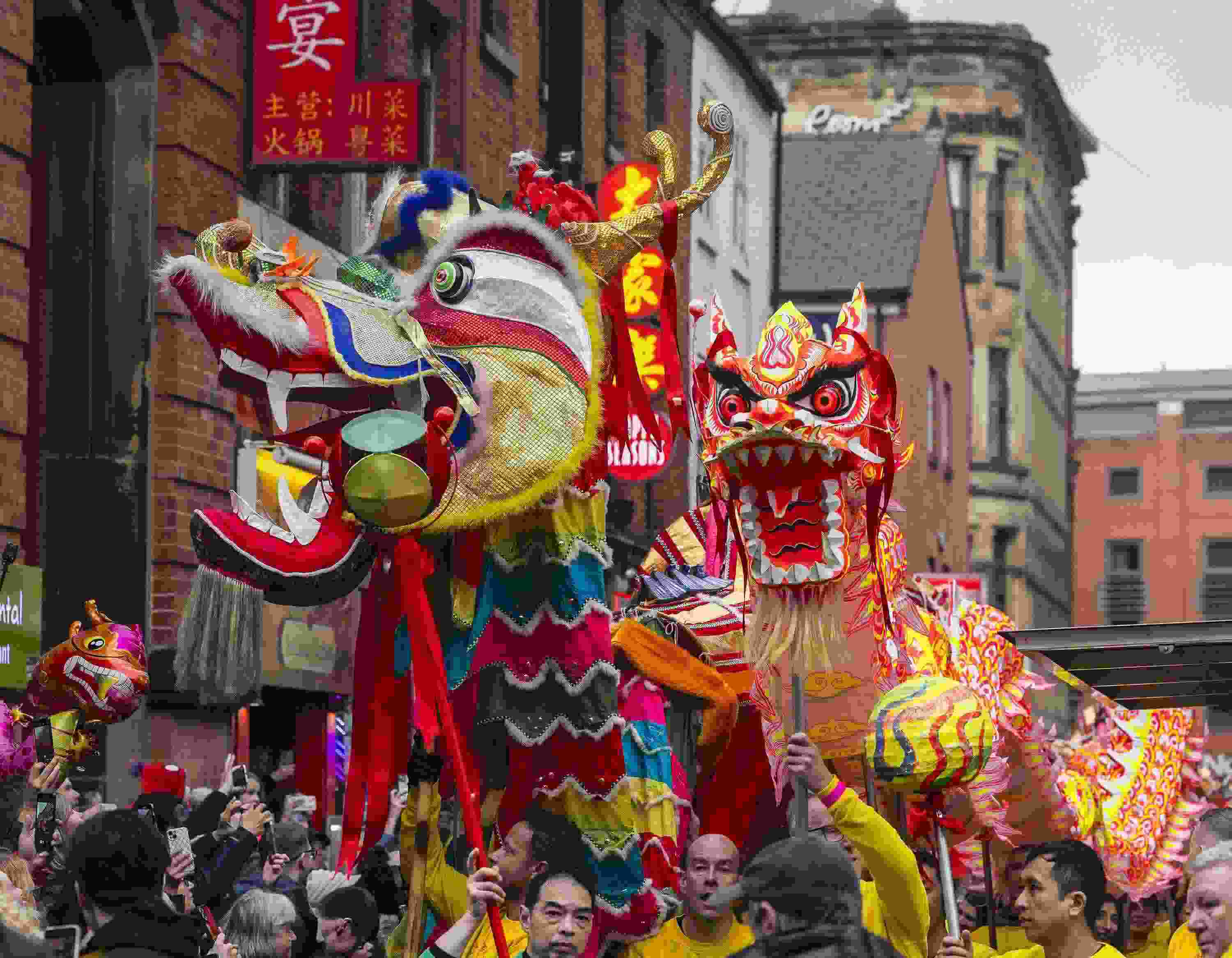 △ 當?shù)貢r間2024年2月11日，英國曼徹斯特，表演者進入中國城，參加中國農(nóng)歷龍年春節(jié)的慶?；顒?。