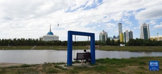 6月30日，一名女子在哈薩克斯坦首都阿斯塔納伊希姆河畔休息。新華社記者 王建華 攝