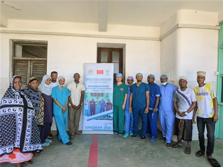 隊長蔣國慶（右七）和手術醫(yī)生、部分患者合影。中國援桑醫(yī)療隊供圖