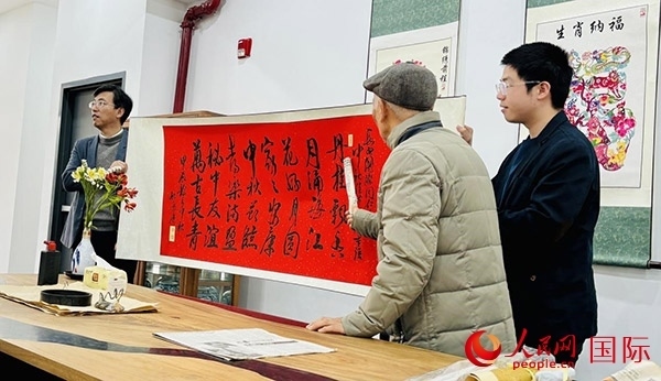 旅秘書法家向現(xiàn)場觀眾展示書法作品。人民網(wǎng)記者 宋亦然攝