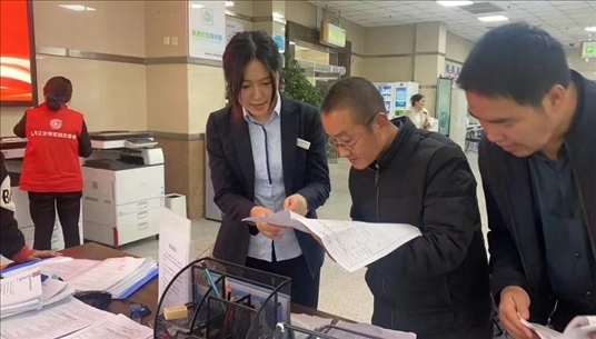 四川省成都市溫江區(qū)市場(chǎng)監(jiān)管局工作人員為群眾提供幫辦服務(wù)。圖片來(lái)源：人民網(wǎng)四川頻道